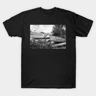 Old canoes and kayaks on the river bank in Thurne, Norfolk T-Shirt